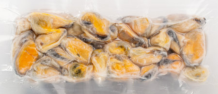 Packed Frozen Mussels Isolated, Unshelled Clam, Frozen Peeled Mussel, Cold Mussels Meat, Iced Seafood, Cooked Shellfish on White Background Top Viewの写真素材