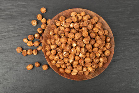 Nut Kernels, Hazelnuts Pile on Plate, Healthy Organic Nuts Group, Nut Kernels on Black Background...
