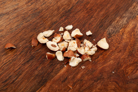 Nut Kernels Crumbs, Broken Hazelnuts Pile, Healthy Organic Crush Nuts Group, Hazel Nut Pieces on Wooden Background Top Viewの写真素材