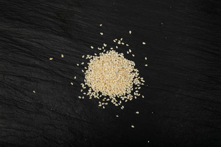 Sesame Seeds Pile, White Sesamum Grains, Healthy Diet Garnish, Sesame Seeds on Black Background Top Viewの写真素材