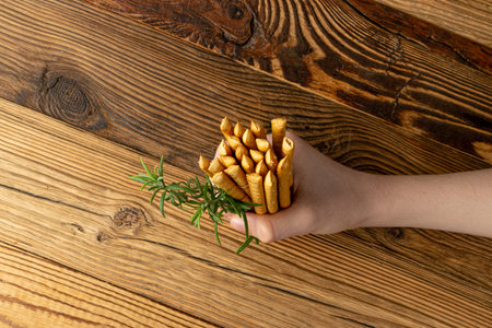 Bread Sticks in Hand, Salted Breadstick, Crispy Grissini, Dry Homemade Pretzels, Bread Stick on...