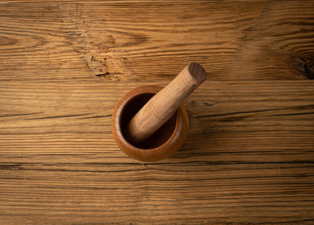 Wooden Mortar, Wood Pounder and Pestle, Empty Mortar Bowl, Vintage Kitchen Equipment on Rustic Table Backgroundの写真素材