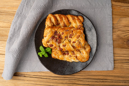 Maple Pecan Puff Pastry, Danish Plaits Pastries with Maple Syrup and Pecan Nuts, Breakfast Bakery, Pate Feuilletee on Wooden Backgroundの写真素材
