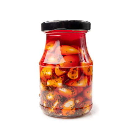 Pickled Garlic in Jar Isolated, Fermented Garlic Cloves with Red Chili Pepper, Hot Pickle Vegetable, Spices Garlic Cloves in Oil and Vinegar on White Backgroundの写真素材