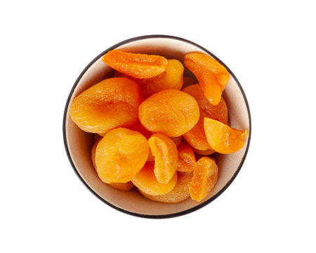 Dry Apricot Stack Isolated, Dried Apricots Pile in Bowl, Healthy Orange Fruits Group, Sweet Organic Dessert Snack, Healthy Diet Food, Dry Apricots on White Backgroundの写真素材
