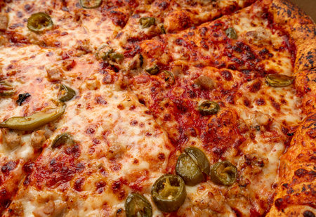 Pepperoni Pizza with Pickled Hot Jalapeno Peppers in Cardboard Delivery Box, Salami Pizza with Green Hot Pepper, Chili Pepper and Mozzarella Cheese, Traditional Italian Flatbreadの写真素材