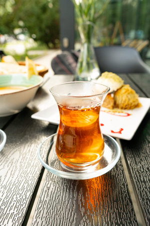 Turkish Tea on a Street Cafe Table, Traditional Arabic Cup in Restaurant, Black Tea Drinking in...
