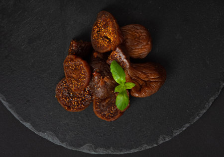 Dry Fig, Dried Ficus Carica Fruit, Sweet Healthy Diet, Tropical Dessert, Wrinkled Dehydrated Snack, Dry Figs on Black Backgroundの写真素材