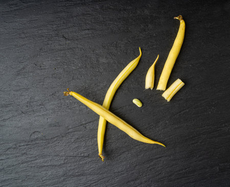 Yellow French Beans on Black Plate, Raw String Beans Pile, Fresh Wax Bean Pods on Dark Stone...