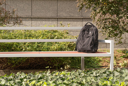 Suspicious backpack on bench. Threat bag as warning terrorism symbolの写真素材