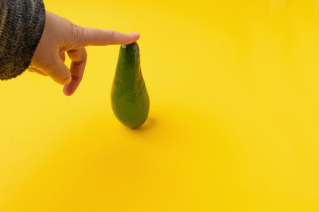 Avocado Isolated, Whole Avokado, One Green Avocado, Single Fresh Alligator Pear, Guacamole Ingredient, Long Avocados Fruit on Yellow Backgroundの写真素材