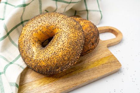 Poppy Seed Bagel, Round Bread Buns, Poppyseed Wheat Bakery for Breakfast, Plain Circle Bagel Bread on Wood Backgroundの写真素材