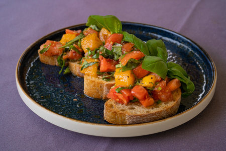Color Bruschetta, Italian Baguette with Red and Yellow Tomatoes, Basil, Healthy Mediterranean Toast, Tomato Sandwiches Crostiniの写真素材