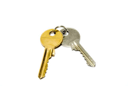Gold and silver keys joint together by a keyringの写真素材