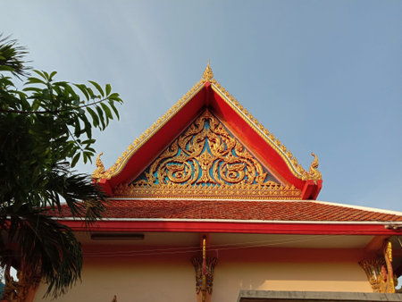 Roof and front of Buddhist temple isolated on blue sky background closeup.Thailand people culture.
