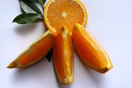 Orange fruit, fruits or vegetables pieces and slices with green leaves  isolated on white background...
