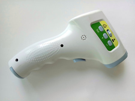 Body infared thermometer on white background closeup.