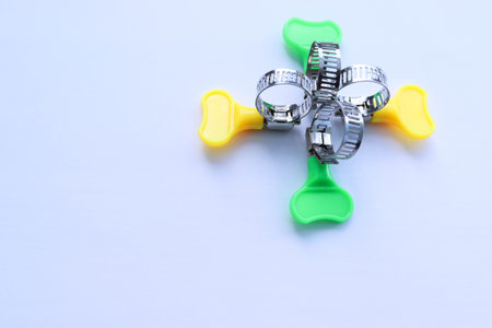 Metal adjustable hose clamps with copy space isolated on white background closeup.