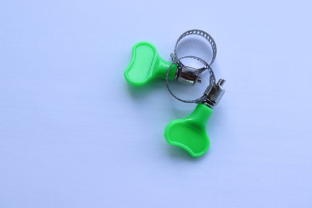 Metal adjustable hose clamps with copy space isolated on white background closeup.