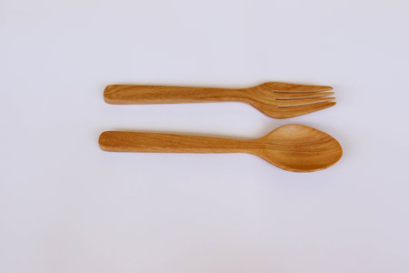 Spoon and fork wooden isolated on white background closeup.