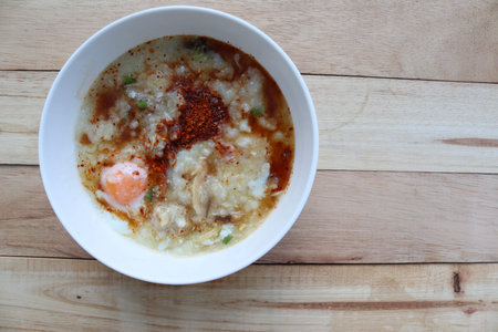 Congee, Rice soup, Rice porridge with egg in the bowl, Thai morning delicious food isolated on...
