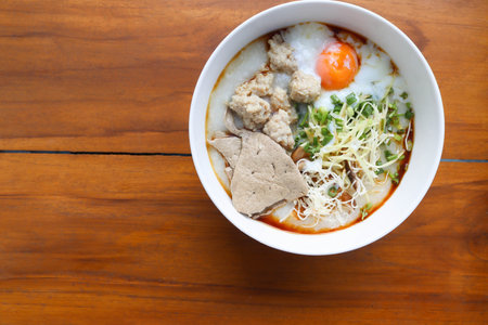 Congee, Rice soup, Rice porridge with egg in the bowl, Thai morning delicious food isolated on...