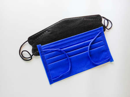 Face mask cloth black, blue for protection coronavirus 2019 (COVID-19), dust pollution isolated on white background closeup.の写真素材