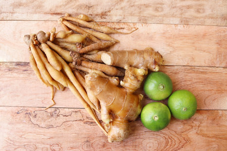 Ginger root and lemon on wooden background, Healthy food concept.