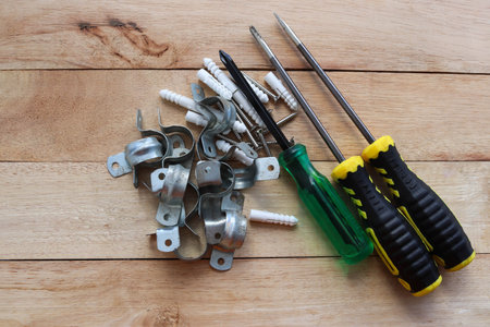 Screwdriver, screwdriver and screws on a wooden background.の写真素材