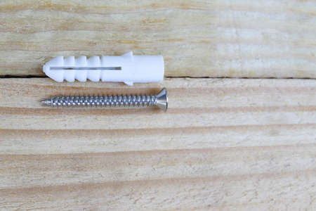 Screws on a wooden background. Repair and construction concept.の写真素材