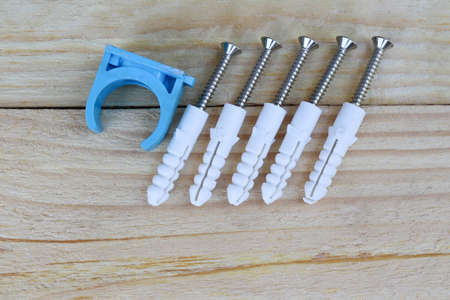 Screws and dowels on a wooden background. Construction tools.の写真素材