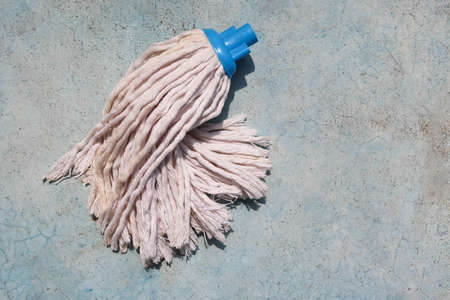 White mop on a blue background. Top view. Copy space.の写真素材