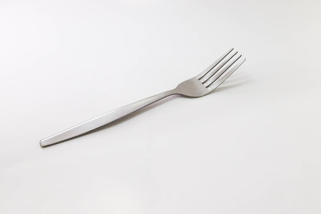 Fork on a white background. Disposable tableware.