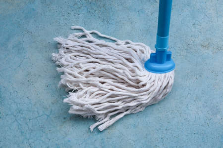 Cleaning mop on blue background. Cleaning service concept.の写真素材