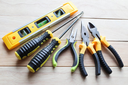 Set of construction tools on wooden background, top view. Repair equipment