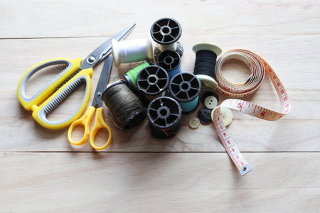Sewing accessories on a wooden background. Sewing tools for sewing.