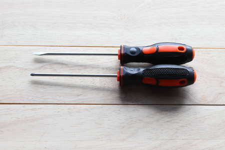 Two screwdrivers on a wooden background, top view. Construction toolsの写真素材