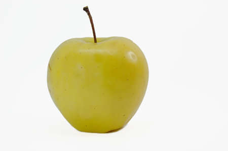 yellow apple isolated on slightly greyの写真素材