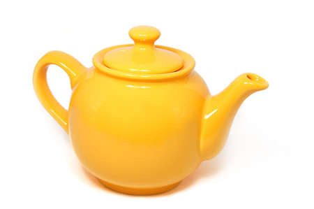 Yellow tea pot isolated on whiteの写真素材