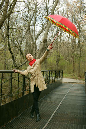 girl on the bridge with red umbrellaの写真素材