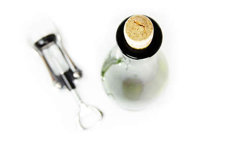 Corkscrew and white wine bottle on white, shallow DOFの写真素材