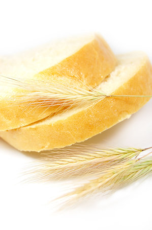 some slices of bread and wheat corns on white