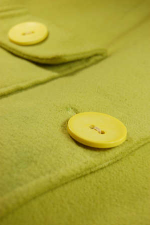 woolen piece of textile with big yellow buttonsの写真素材
