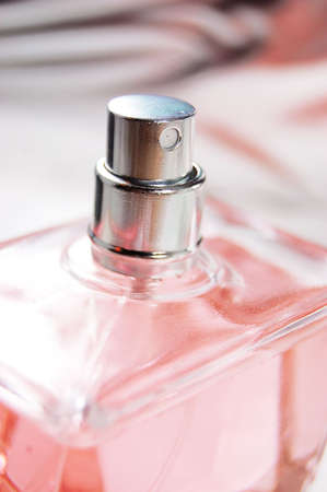 detail of pink bottle of perfume on metalic backの写真素材