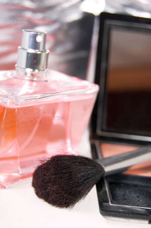 Brush, powder and pink bottle of parfumの写真素材