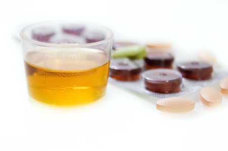 mixture dosage and some pills isolated on whiteの写真素材