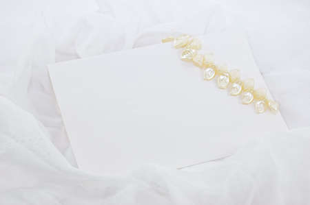 blank note with decoration over white fabricの写真素材