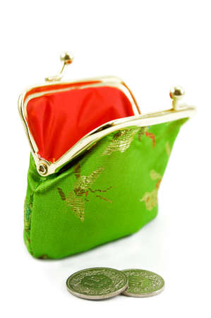 Green purse with some coins in front of itの写真素材