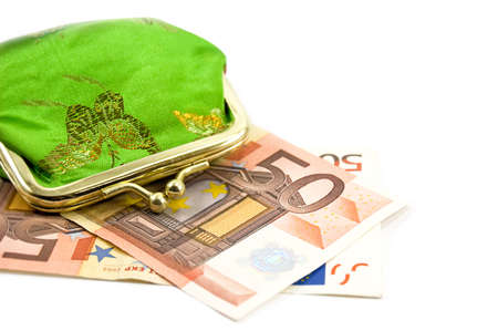 Green purse over fifty euro banknote on whiteの写真素材