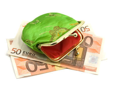 Green purse over fifty euro banknote on whiteの写真素材
